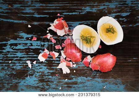 Colorful Easter Egg. Background With Easter Eggs Cut In Half With Green Dill. Two Halves. Red Boiled