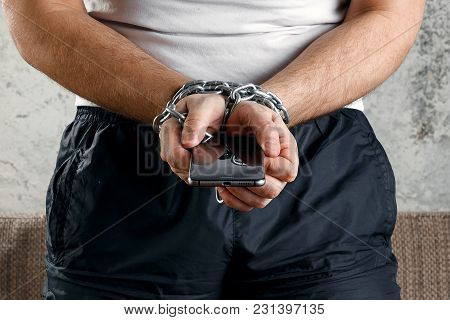 Close-up, The Man's Hand Is Tied With A Chain To The Smartphone. The Concept Is Dependent On Technol