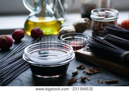 Black Rice Vermicelli, Vinegar And Vegetables On A Black Slate. Asian Cuisine Horizontal