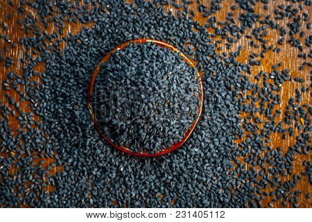 Close Up Of An Essential Beneficial Ayurvedic Herb I.e Kalonji Or Black Caraway In A Wooden Plate On