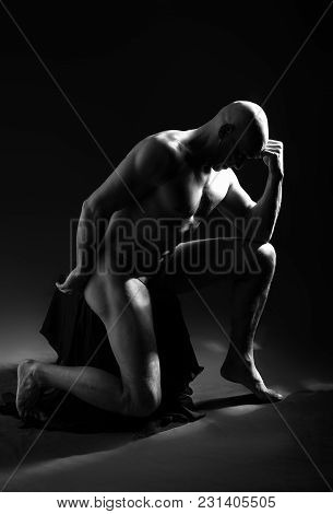 Studio Portrait Of Athletic Man. Body Skulptur. Monochrome Photo.