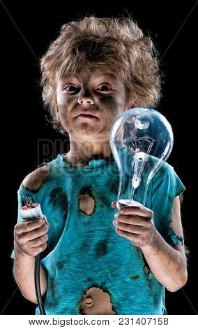 Portrait of funny little electrician with lightbulb over black background