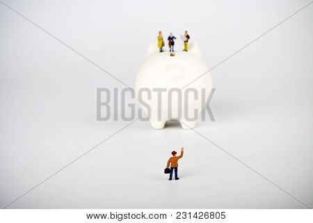 Businessman Figurines On A Piggybank. Money, Business, Corruption And Expectation Concept.