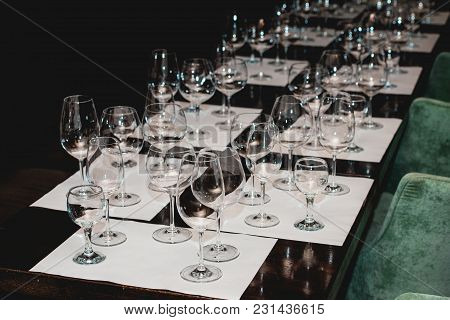 Empty Glasses Of Different Shapes Served In A Restaurant For A Wine Tasting. Sommelier At Wine Tasti