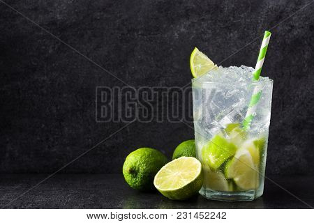 Caipirinha Cocktail In Glass On Black Stone. Copyspace