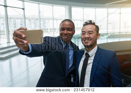 Happt Multi-ethnic Business Partners Taking Selfie In Airport