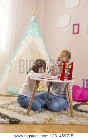 Mother And Daughter Studying Math Through Fun, Learning Summation And Subtraction With Abacus