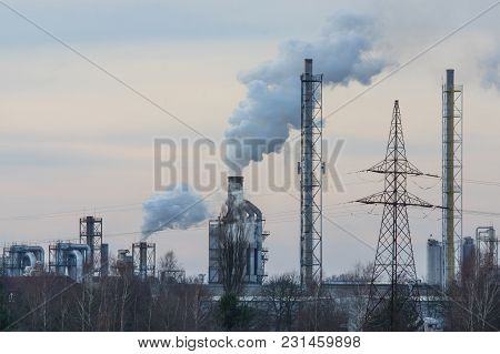 A Vast, Flat Area. In The Distance You Can See A Factory, A Shiny Metal Structure .. From The Chimne
