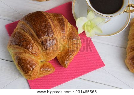 Vintage Coffee Cup With Espresso On A Saucer, Croissant On The Rose Table-napkin, Green Orchid Flowe