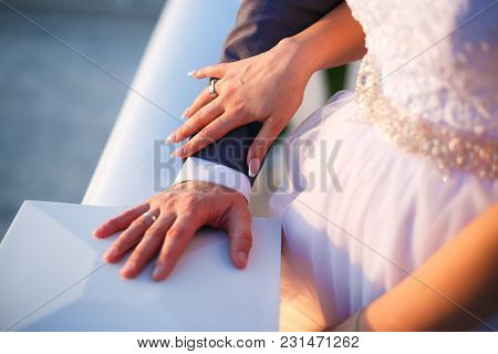 Bride Holding Grooms Hand At Sunset Time