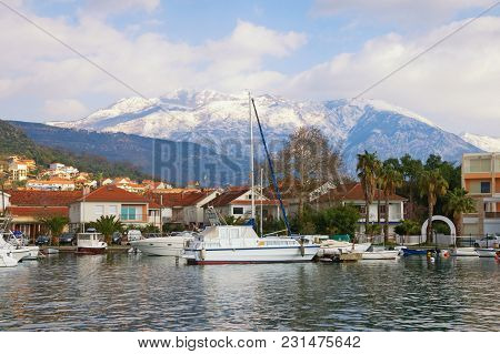 Green Mediterranean Town At The Foot Of The Snow-capped Mountains.   Montenegro. View Of Marina Kali