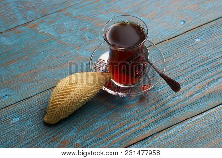 Glass Of Tea With Azerbaijan Pastry Shekerbura And Wheat Grass Semeni On Blue Wooden Table Backgroun