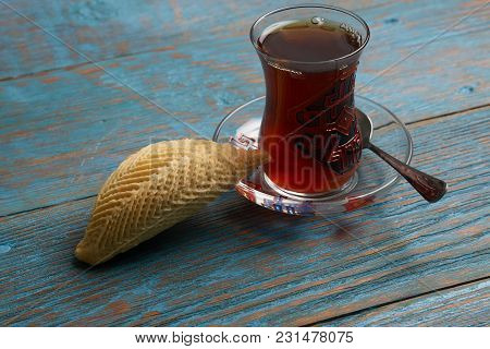 Glass Of Tea With Azerbaijan Pastry Shekerbura And Wheat Grass Semeni On Blue Wooden Table Backgroun