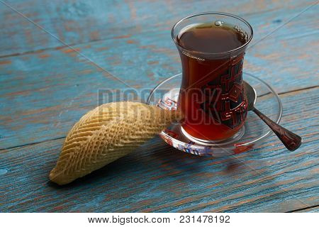 Glass Of Tea With Azerbaijan Pastry Shekerbura And Wheat Grass Semeni On Blue Wooden Table Backgroun