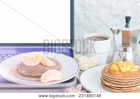 Laptop With White Blank Screen On Table With Breakfast: Pancakes With Sliced Mandarines And Orange J