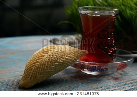 National Azerbaijan Pastry Shekerbura With Nuts And Honey And Glass Of Black Tea On Wooden Table Wit