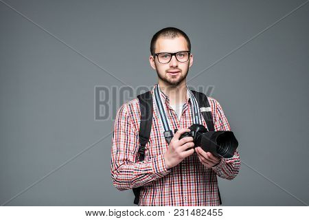 Professional Male Photographer With Digital Photo Camera In Photo Studio, Isolated On Grey