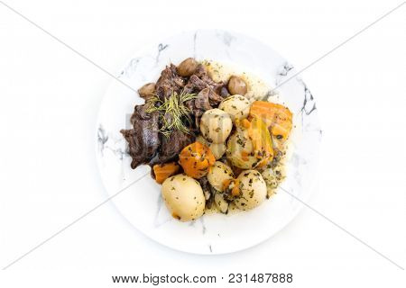 Beef meat stewed with potatoes-Traditional French cuisine Beef Bourguignon potatoes carrots in persillade