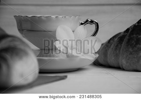Vintage Coffee Cup With Espresso On A Saucer, Croissant On A Table-napkin, Orchid Flower On A Painte