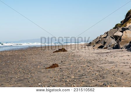 Empty Swamis Beach Dotted With Seaweed And Stones In Encinitas, California.  Swamis Is An Internatio