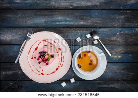 Caramel Cheesecake With Strawberry With Cup Tea And Cutlery On The Wooden Background Top View