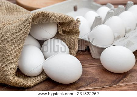 Sack Bag With Raw Eggs And Carton Container For Eggs On The Table.