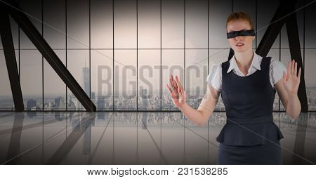 Digital composite of Business woman blindfolded against window and skyline