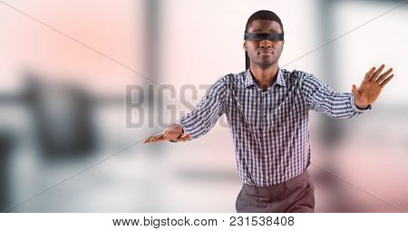 Digital composite of Business man blindfolded against blurry grey office with red overlay
