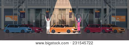 Couple Of Arab Seller Presenting New Car In Dealership Center Showroom Over Set Of New Vechicles Hor
