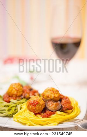 Two-colour Green And Yellow Italian Coocked Pasta With Meatballs, Tomatoes And Eggplant. Copy Space