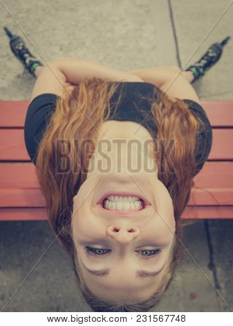 Close Up Of Funny Young Teenage Woman Wearing Rolling Skates. Bizzare Unusual Angle. Outdoor Shot.