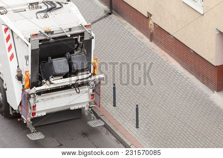 Modern White Garbage Dustcart Truck On City Street. Recycling In Town Concept.