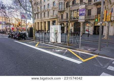 Barcelona, Spain. February 2018: Charging Station In Barcelona, Passeig De Gracia, And Sign On The S