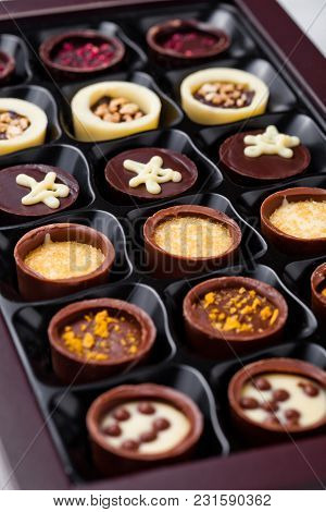 Assortment Of Luxury White And Dark Chocolate Candies Variety In Black Plastick Tray