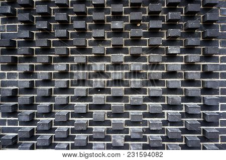 Modern black brick wall pattern and texture. Architectural background.