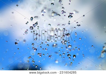 Fountain Water Splashing. Abstract Colorful  Background With Water Splatter. Drops Falling In The Ai