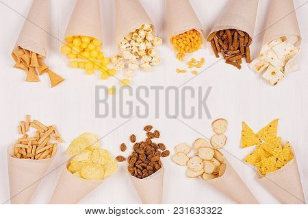 Joyful Summer Snacks Set On Beige Paper Cones On Soft White Wood Background. Top View, Copy Space.