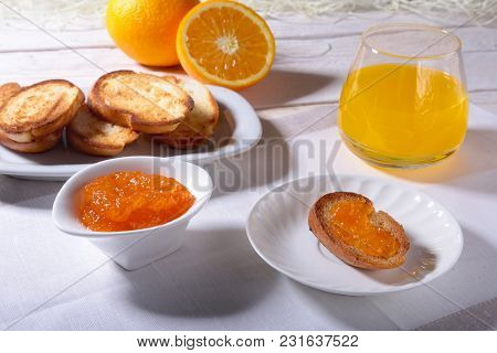 Morning Breakfast Set With Orange Jam On Bread Toast And Juice In Glass