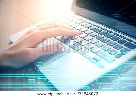 Hands Typing On Laptop Keyboard Placed On Abstract Background With Glowing Digtal Interface. Innovat