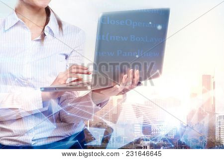 Businesswoman Hands Using Laptop Computer On Abstract City Background With Glowing Digtal Interface.