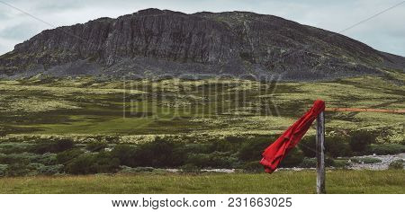 Flying Red Raincoat In Norway National Park Rondane