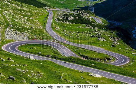 Serpentine Road In Fagarasan Mountains. Lovely Transportation Background. Popular Tourist Destinatio