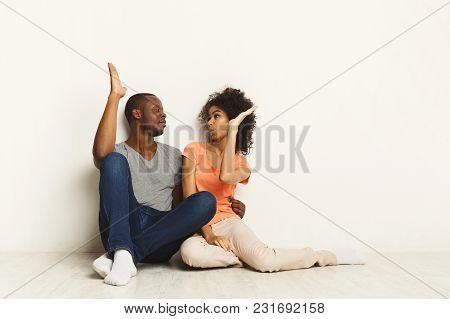 Happy African-american Family Couple Hugging And Talking, Giving High-five, Sitting On Floor In New 