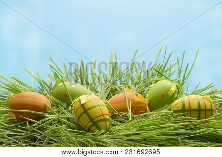 Easter Eggs In The Grass Against The Sky. Happy Easter