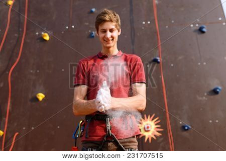 Close Up Of Climber Man Coating Hands In Powder Chalk Magnesium And Preparing To Climb Outdoor Train
