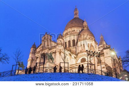 The Basilica Sacre Coeur Covered With Snow. It Is A Roman Catholic Church Located At The Summet Of T