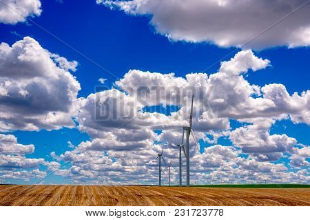 Wind Powered Electricity Generators Sitting In A Field. Located In Eastern Oregon.