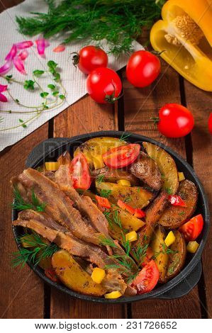 Fried Potatoes With Bacon And Fresh Tomatoes In The Frying Pan. Wooden Rustic Background. Top View.