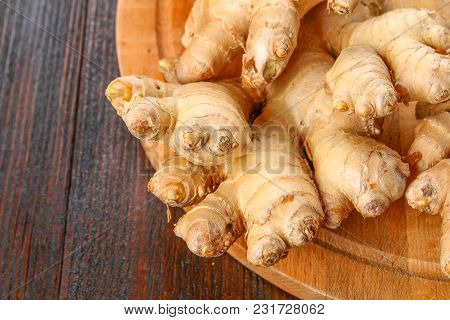 Spicy Root Of Ginger On A Wooden Table
