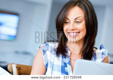 Woman with papers in their living room